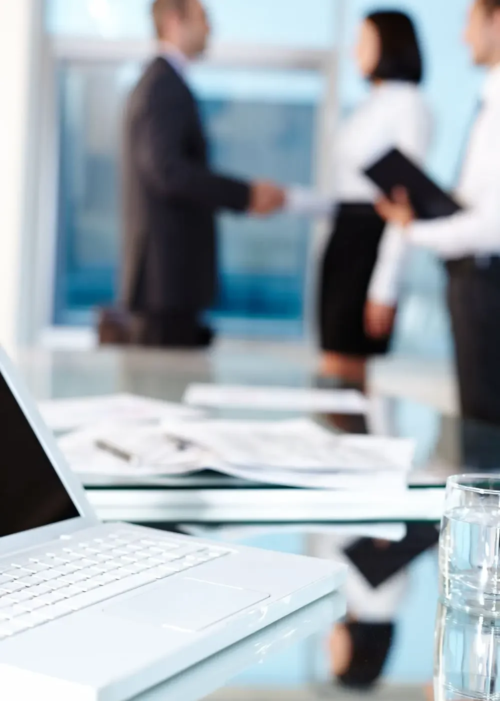 HR specialist conducting a confidential workplace investigation with documents and a digital recorder on the table.